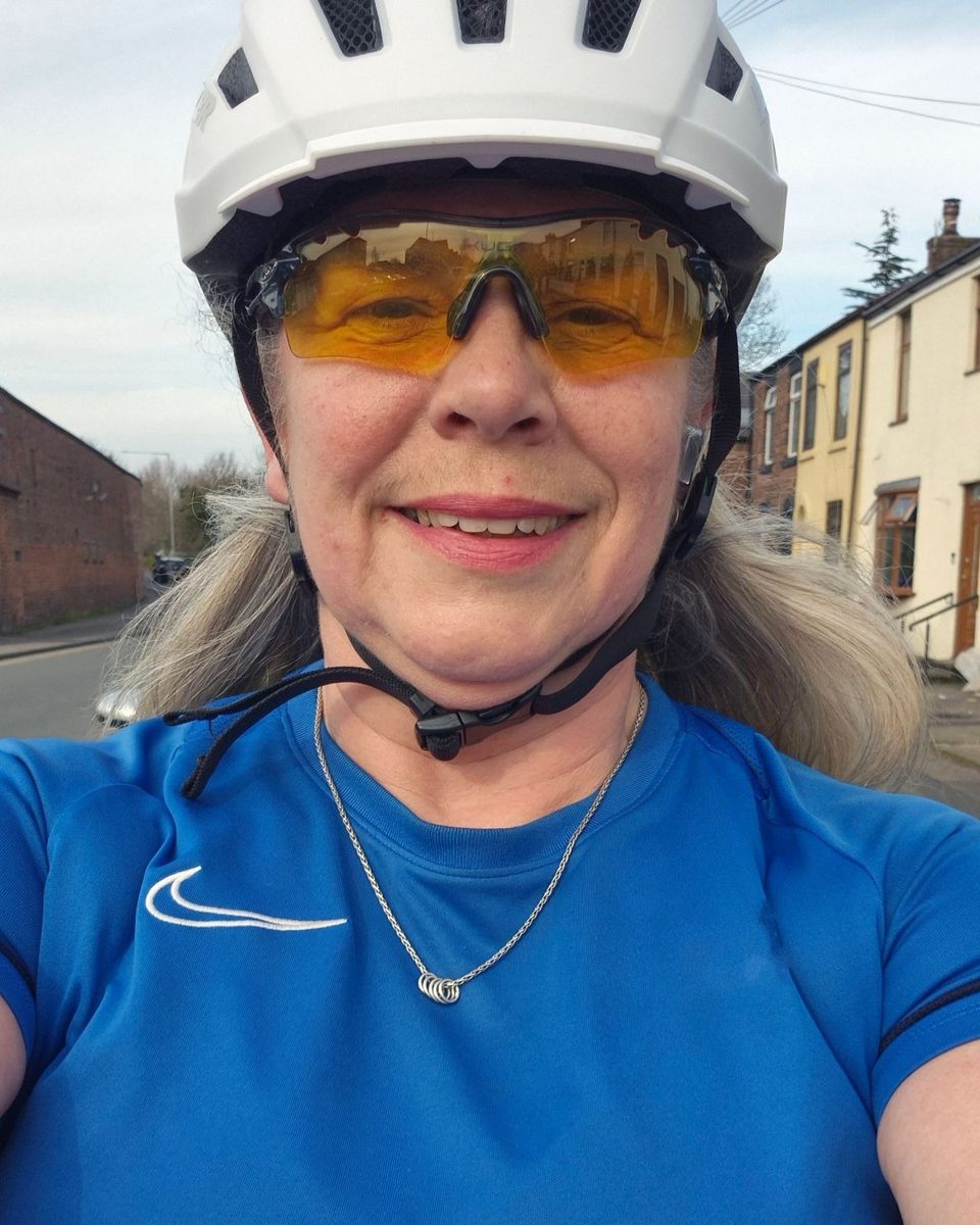 Manda smiling in her cycling helmet and sunglasses